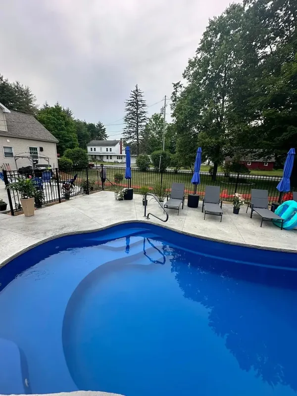 Fiberglass pool installation Saratoga NY with stamped concrete pool deck